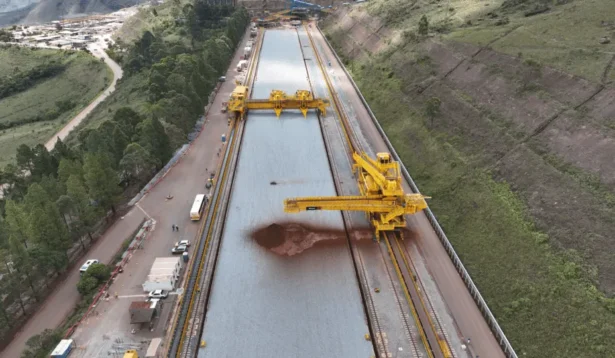 Mina de Capanema com pátio e área de homogeneização, mostrando correias e maquinário amarelo operando sobre o pátio de armazenagem.